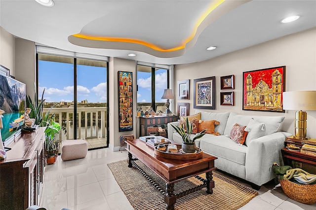 living room featuring light tile patterned floors and a wall of windows