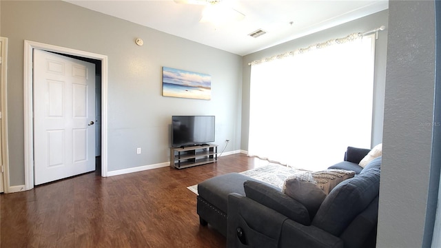 living room featuring dark hardwood / wood-style floors and ceiling fan