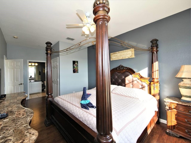 bedroom with ceiling fan, dark wood-type flooring, and ensuite bath