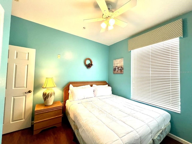 bedroom featuring ceiling fan and dark wood-type flooring