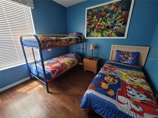 bedroom with dark wood-type flooring