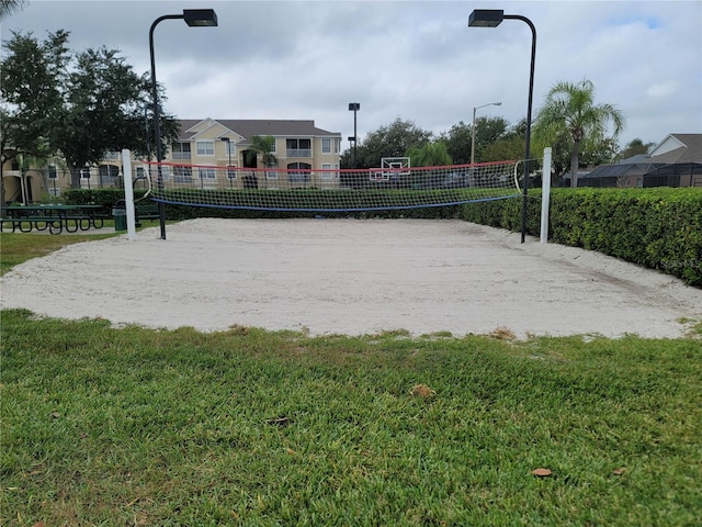 surrounding community featuring a lawn and volleyball court