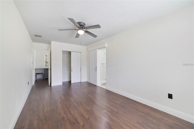 unfurnished bedroom with a closet, ceiling fan, and dark wood-type flooring