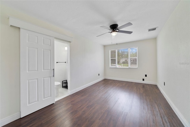 empty room with dark hardwood / wood-style floors and ceiling fan