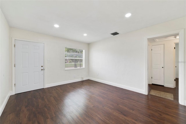 empty room featuring dark hardwood / wood-style flooring