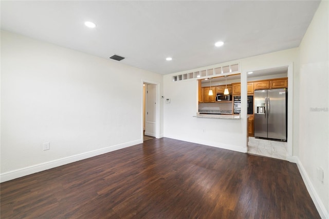 unfurnished living room with wood-type flooring