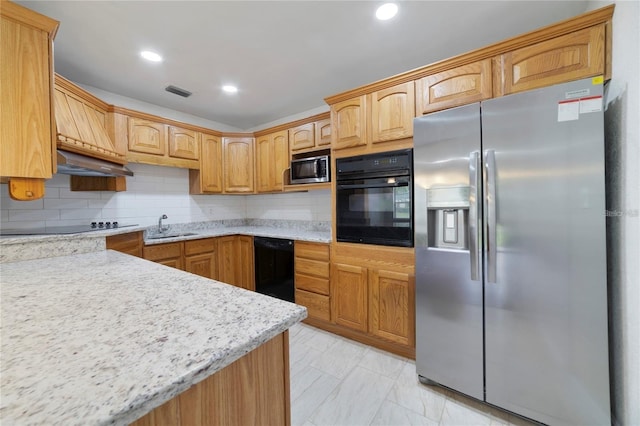 kitchen with black appliances, sink, range hood, tasteful backsplash, and light stone counters