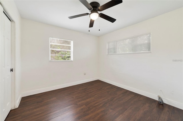 empty room featuring ceiling fan and dark hardwood / wood-style flooring