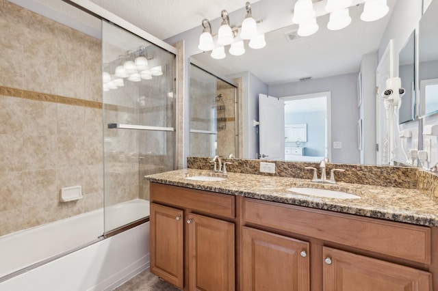 bathroom featuring vanity and bath / shower combo with glass door