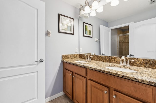 bathroom featuring tile patterned flooring, vanity, and a shower with shower door