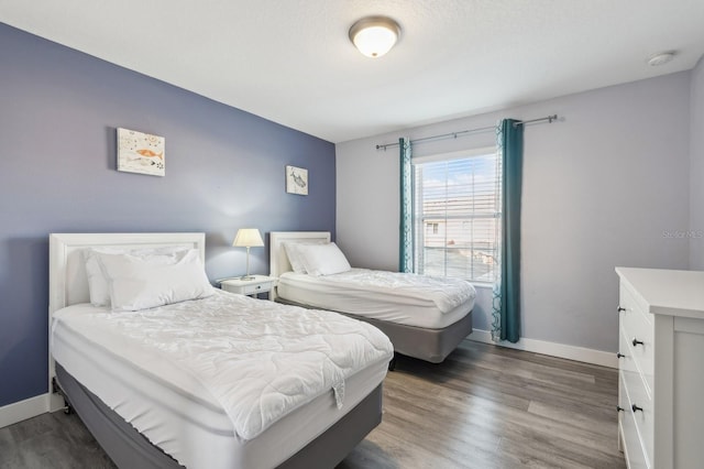 bedroom with dark hardwood / wood-style flooring