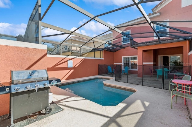 view of pool featuring glass enclosure and a patio area