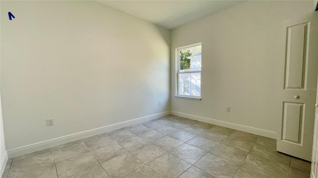 unfurnished room featuring light tile patterned floors