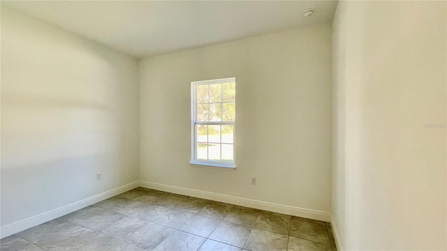 unfurnished room featuring light tile patterned floors