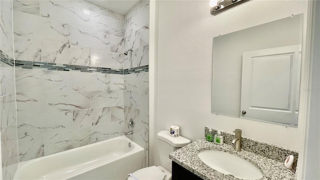 full bathroom featuring vanity, tiled shower / bath combo, and toilet