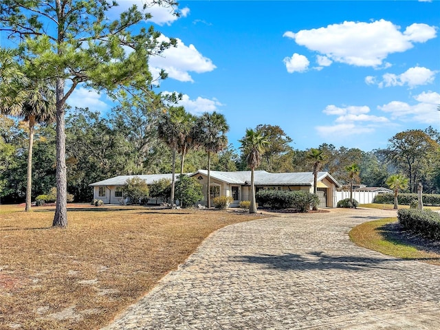 ranch-style house with a front lawn