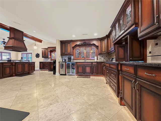 kitchen with decorative backsplash, light tile patterned floors, dark brown cabinetry, and wine cooler