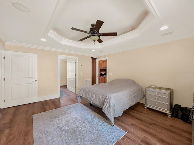 bedroom with ceiling fan, dark hardwood / wood-style floors, and a raised ceiling