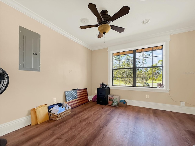 empty room with hardwood / wood-style floors, ceiling fan, ornamental molding, and electric panel