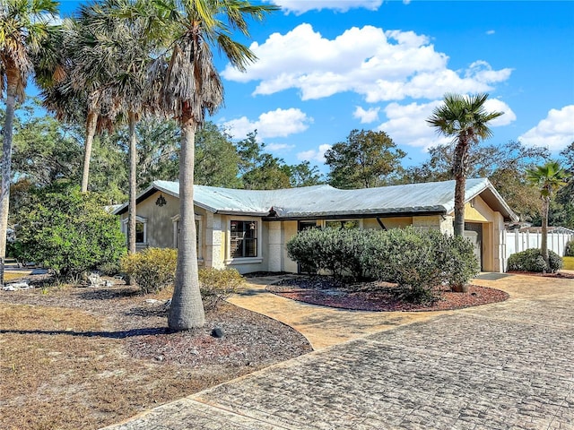 ranch-style home featuring a garage