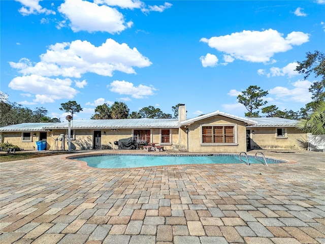 view of swimming pool featuring a patio