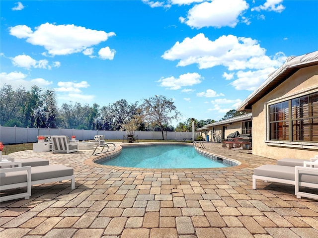 view of pool featuring outdoor lounge area and a patio