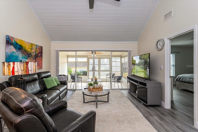 living room with wood-type flooring and high vaulted ceiling