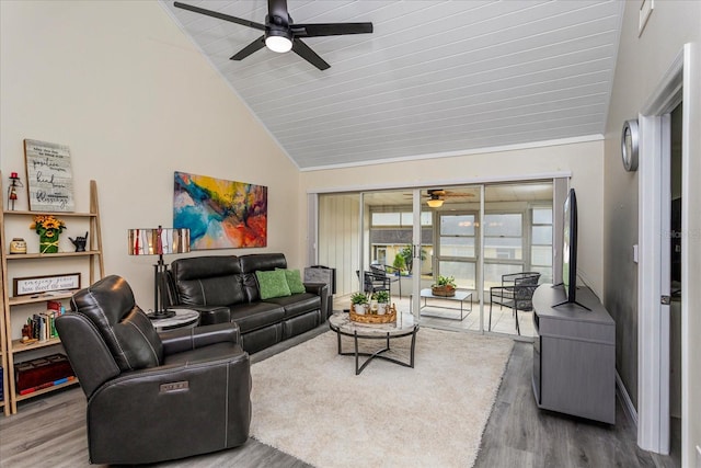 living room with ceiling fan, hardwood / wood-style floors, and high vaulted ceiling