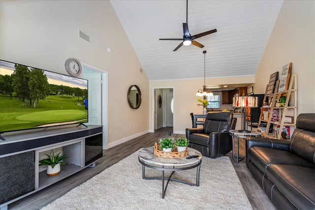 living room with high vaulted ceiling, dark wood-type flooring, and ceiling fan with notable chandelier