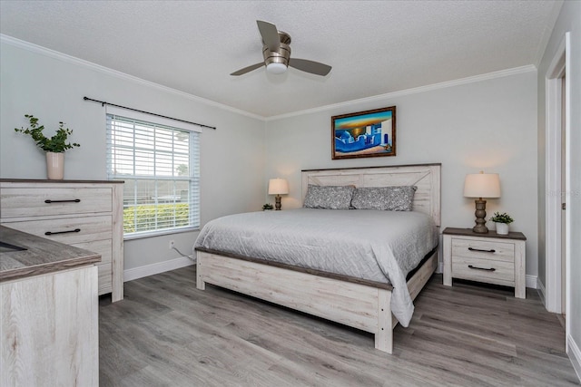 bedroom with a textured ceiling, ceiling fan, ornamental molding, and dark wood-type flooring