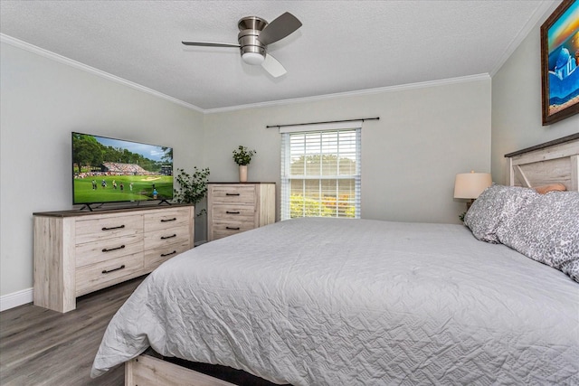 bedroom featuring ceiling fan, dark wood-type flooring, a textured ceiling, and ornamental molding