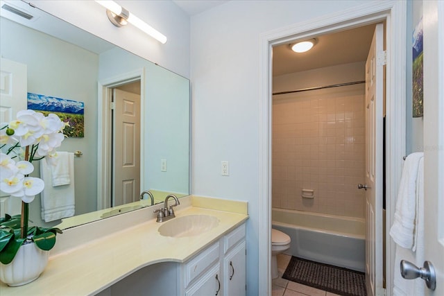 full bathroom featuring tile patterned floors, vanity, toilet, and tiled shower / bath