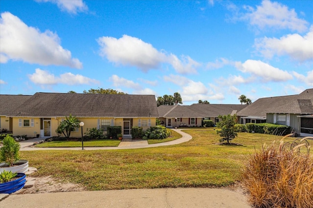 single story home with a front yard