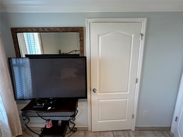 room details with ornamental molding and hardwood / wood-style flooring