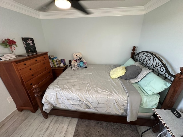 bedroom featuring light hardwood / wood-style flooring, ceiling fan, and ornamental molding