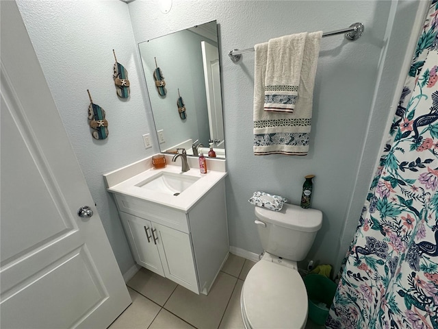 bathroom with tile patterned floors, vanity, and toilet