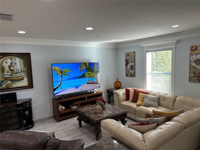 living room featuring ornamental molding, a textured ceiling, and light hardwood / wood-style flooring