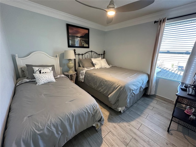 bedroom with ceiling fan, light hardwood / wood-style floors, and crown molding