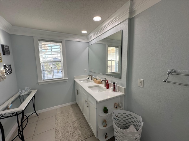 bathroom with tile patterned floors, vanity, ornamental molding, and a textured ceiling