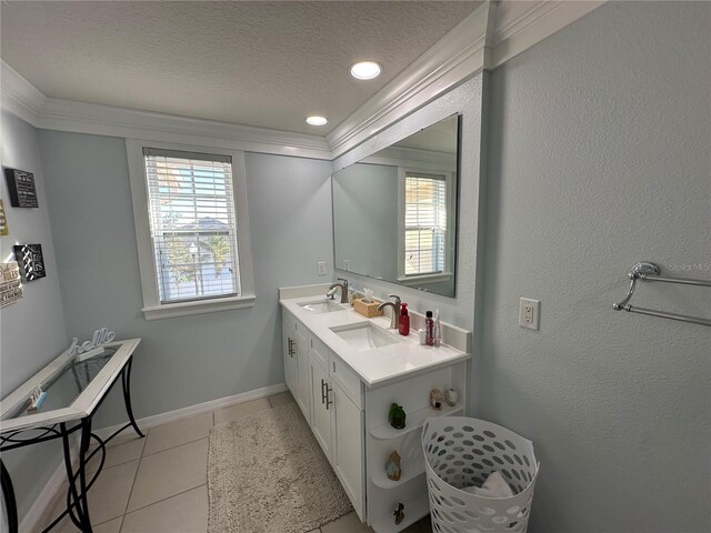4803 Apple Blossom Ln Unit 4803, Saint Cloud, FL 34771 - bathroom with a textured ceiling, crown molding, tile patterned floors, double vanity, and baseboards