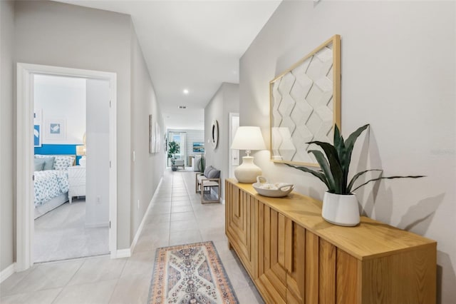 hall featuring light tile patterned flooring