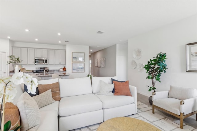 living room with sink and light hardwood / wood-style floors