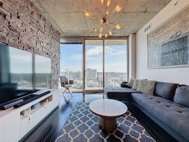 living room featuring dark hardwood / wood-style flooring, an inviting chandelier, and expansive windows