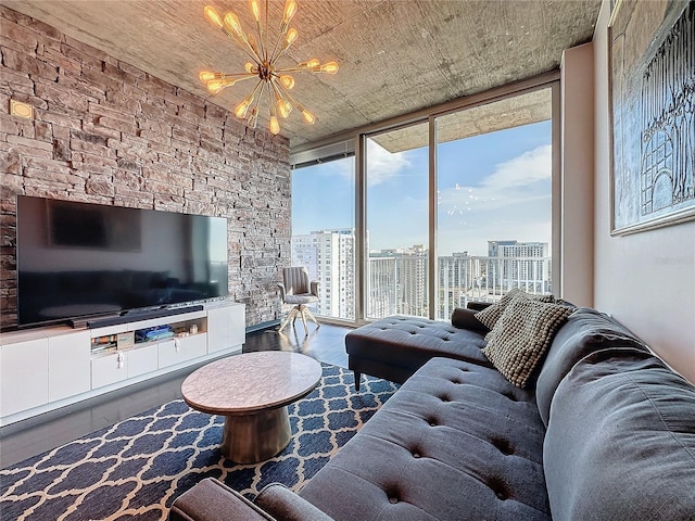 living room with floor to ceiling windows, a chandelier, and hardwood / wood-style flooring