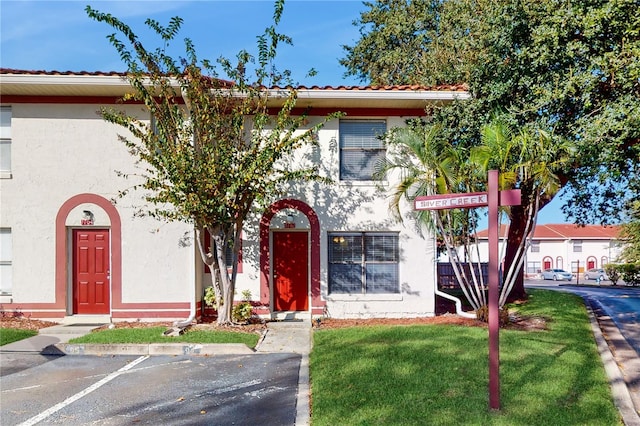 mediterranean / spanish house featuring a front lawn