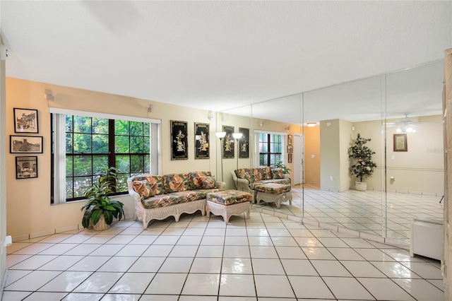 unfurnished living room featuring ceiling fan and light tile patterned floors