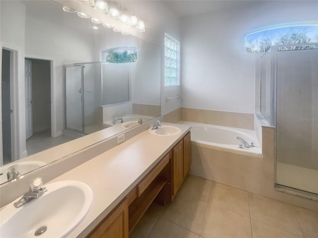 bathroom with vanity, tile patterned flooring, and plus walk in shower