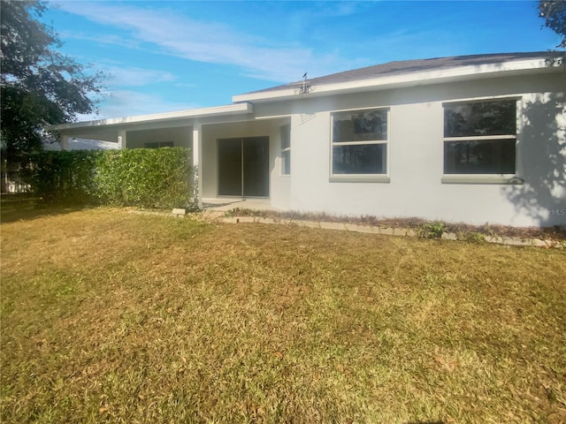 rear view of property with a yard