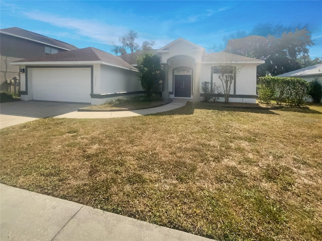 view of front of property featuring a garage and a front lawn