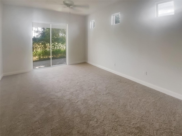 carpeted spare room featuring ceiling fan